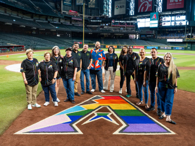PHOENIX AZ — JUNE 26: The D-backs LGBTQ+ TPRG and community members fill in the Pride Night A logo on June 26, 2025 in Phoenix, Arizona. (Photo by Kelsey Grant/Arizona Diamondbacks)