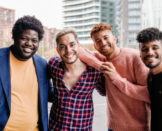 Diverse trendy group of friends having fun outdoor - Diversity and multiracial people - Focus on non-binary gay man
