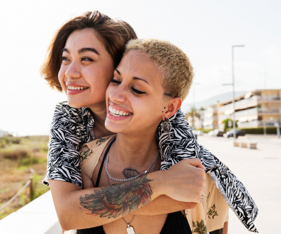 Beautiful lesbian couple of lovers dating outdoors Beautiful multiethnic lesbian couple of lovers dating outdoors - LGBT people bonding and spending time together, concepts about LGBTQ community, diversity, love and lifestyle
